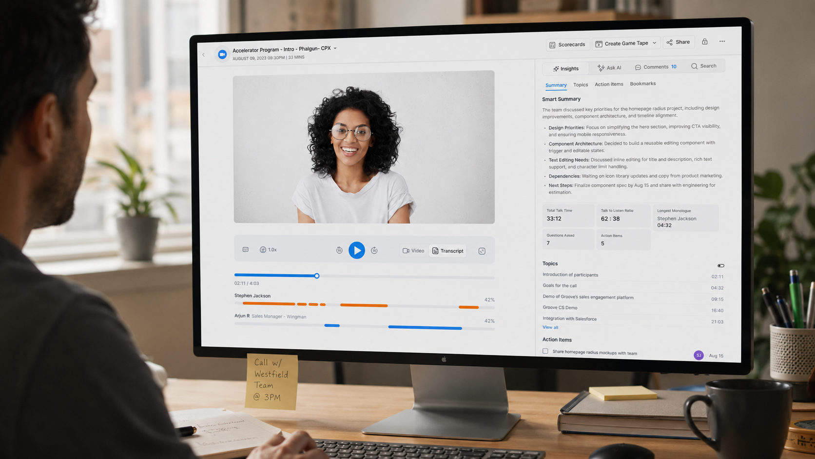 The redesigned Clari Copilot Call Review shown on a monitor: video, speaker timelines and an AI insights panel